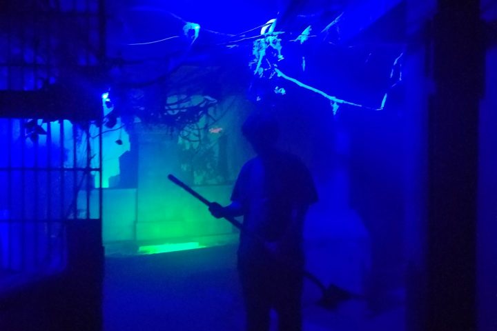 a man standing on a stage in front of a flat screen tv